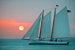Sailboat on the water as the sunsets at the Key West Historic Seaport in Key West.